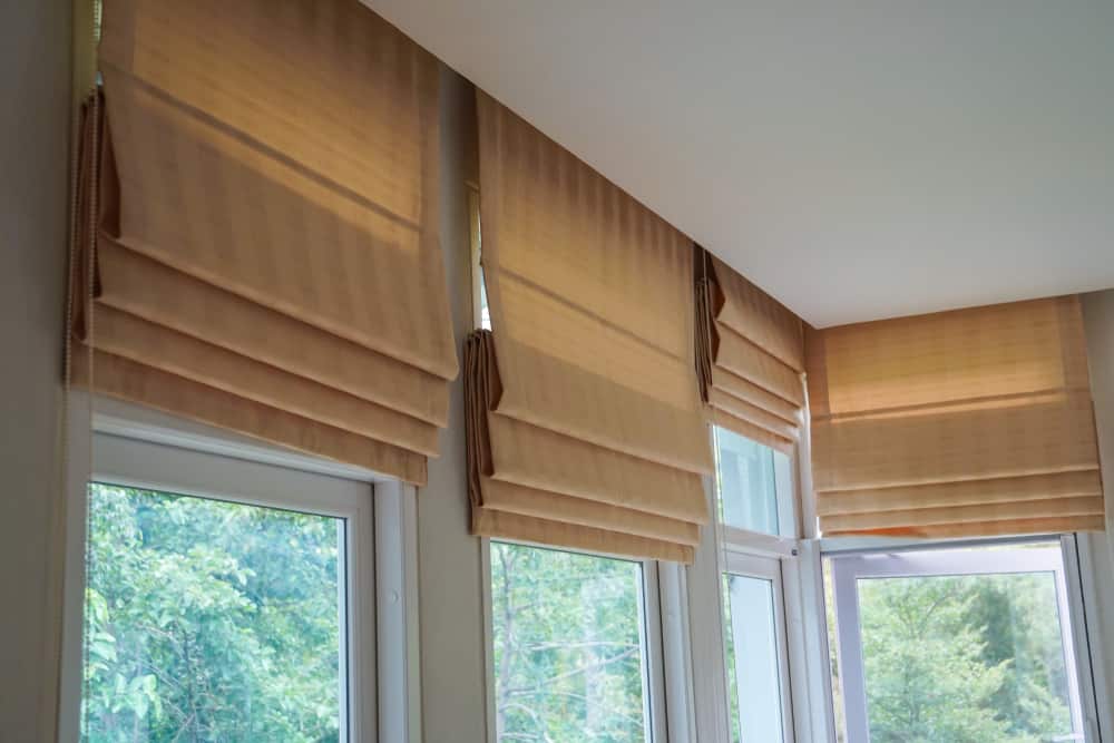 brown roman blinds shade curtain on a forest mountain background